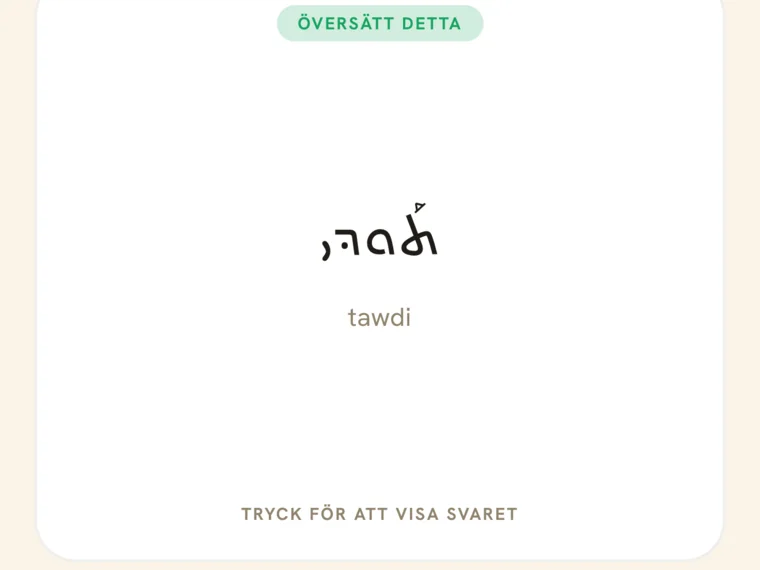 Ett repetitionskort i appen med ordet tawdi skrivet i stor serto-skrift.